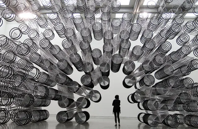 A woman looks at an art installation named “Forever Bicycles” by dissident Chinese artist Ai Weiwei during a media preview of the “Ai Weiwei Absent” exhibition in Taipei October 28, 2011. (Photo by Pichi Chuang/Reuters)