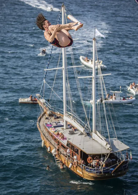 This handout photo released by Red Bull and taken on August 27, 2016 shows of USA's Ginger Leigh Huber diving from the 21.5-metre-high platform during the first competition day of the fifth stop of the Red Bull Cliff Diving World Series at Polignano a Mare. (Photo by Dean Treml/AFP Photo)