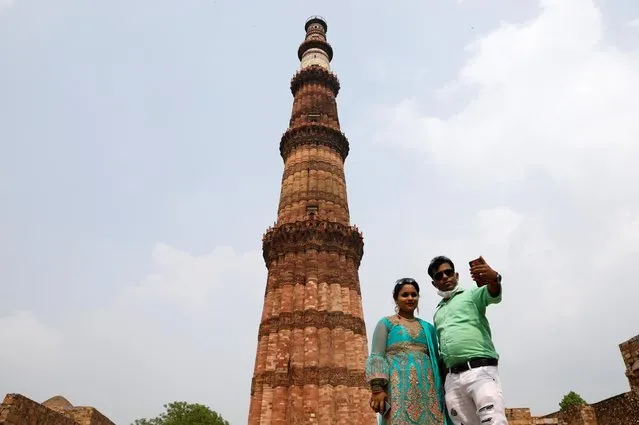 A couple takes selfie in front of Qutub Minar, after authorities reopened it for visitors following a three-month lockdown that was imposed to slow the spread of the coronavirus disease (COVID-19), in New Delhi, India on July 6, 2020. (Photo by Adnan Abidi/Reuters)