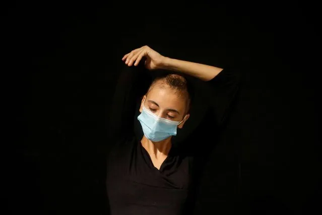 A Palestinian girl wearing a mask rehearses for a performance at the Freedom Theatre amid the coronavirus disease (COVID-19) crisis in Jenin in the Israeli-occupied West Bank on July 16, 2020. (Photo by Raneen Sawafta/Reuters)