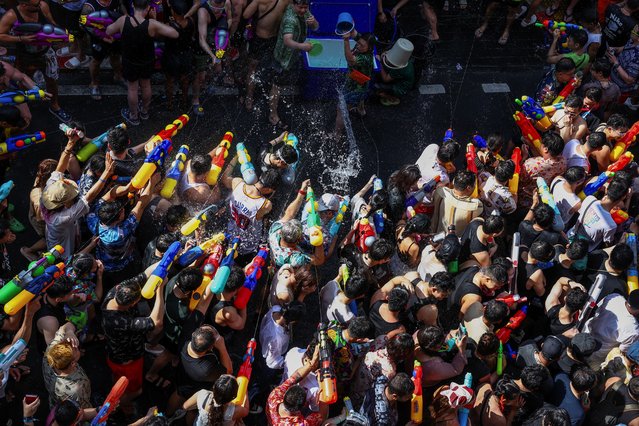 Revellers play with water as they celebrate the Songkran holiday, which marks the Thai New Year, in Bangkok, Thailand, on April 13, 2025. (Photo by Chalinee Thirasupa/Reuters)