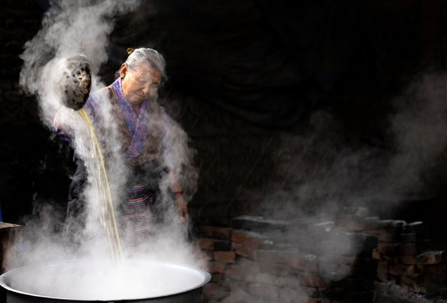 An elderly Tibetan woman cooks tea before a function to mark Losar, or Tibetan New Year, in Kathmandu, Nepal, 28 February 2025. A small number of exiled Tibetans gathered to celebrate New Year in the Nepali capital. (Photo by Narendra Shrestha/EPA/EFE)