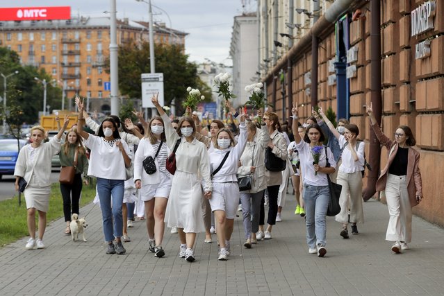 About 200 women march in solidarity with protesters injured in the latest rallies against the results of the country's presidential election in Minsk, Belarus, Wednesday, August 12, 2020. Belarus officials say police detained over 1,000 people during the latest protests against the results of the country's presidential election. (Photo by AP Photo/Stringer)