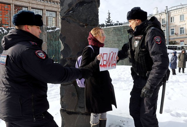Police officers detain a woman holding a placard reading “murderers” during a gathering in memory of the opposition leader Alexei Navalny in Moscow, Russia on February 17, 2024. (Photo by Reuters/Stringer)