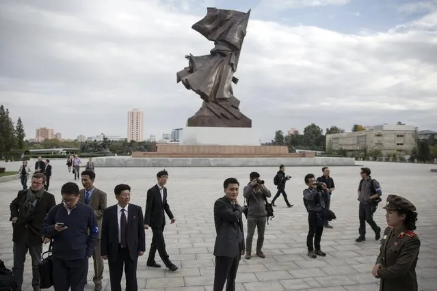 A soldier (R) welcomes foreign reporters and officials at the doors of War Museum during a government organised tour in Pyongyang, North Korea October 9, 2015. (Photo by Damir Sagolj/Reuters)