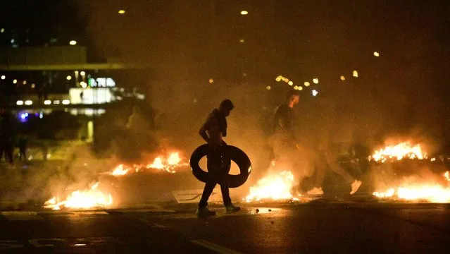 Demonstrators burn tyres during clashes with police in the Rosengard neighbourhood of Malmo, Sweden, on August 28, 2020. The protest was sparked by the burning of a coran by members of Danish far-right party Stram Kurs during an anti-Muslim rally in Malmo earlier in the day. The party's leader Rasmus Paludan, known for his anti-Muslim rhetoric, was due to attend the rally but he was arrested near Malmo and has been banned from Sweden for two years, authorities said on August 28. (Photo by TT News Agency via AFP Photo)