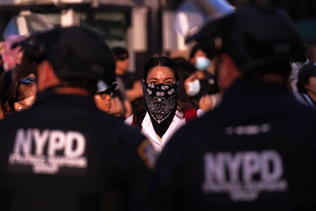 A person faces off with NYPD officers during a protest against deportations and ICE outside of federal buildings on June 10, 2025 in New York City. Federal agents are arresting immigrants during mandatory check-ins, as ICE ramps up enforcement following immigration court hearings. The Trump administration has ordered officials to increase detentions to 3,000 migrants per day. (Photo by Adam Gray/Getty Images/AFP Photo)