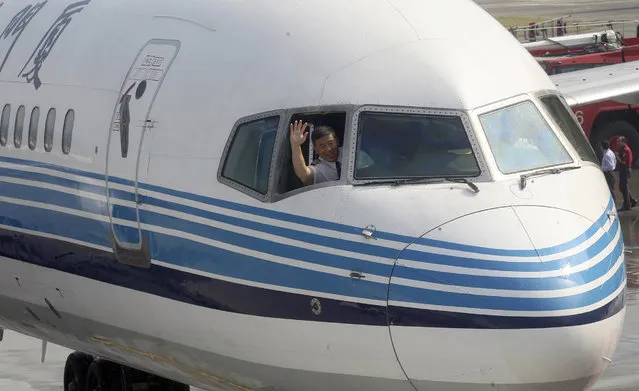In this July 4, 2008, file photo, the pilot of the Xiaman Airline plane carrying the first group of Chinese tourists to arrive in Taipei from Xiamen, waves from the cockpit after landing at the Songshan airport in Taipei, Taiwan. Taiwan refused to allow two Chinese airlines, Xiamen Airlines and China Eastern Airlines, to expand service to the island during the Lunar New Year holiday, a news agency reported Monday, January 29, 2018, after Beijing angered Taiwan’s government by approving new air routes. (Photo by Hsu Chao Chang/Pool Photo via AP Photo)