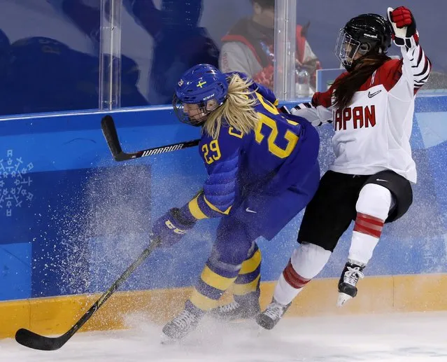 Olivia Carlsson of Sweden and Sena Suzuki of Japan (R) in action in the women' s classifications (5-8) ice hockey match between Sweden and Japan during the Pyeongchang 2018 Winter Olympic Games at the Kwandong Hockey Centre in Gangneung on February 18, 2018. (Photo by Kim Kyung-Hoon/Reuters)