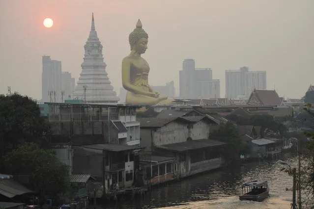 The giant Buddha statue of Wat Paknam Phasi Charoen temple is seen amid air pollution in Bangkok, Thailand on February 2, 2023. (Photo by Chalinee Thirasupa/Reuters)