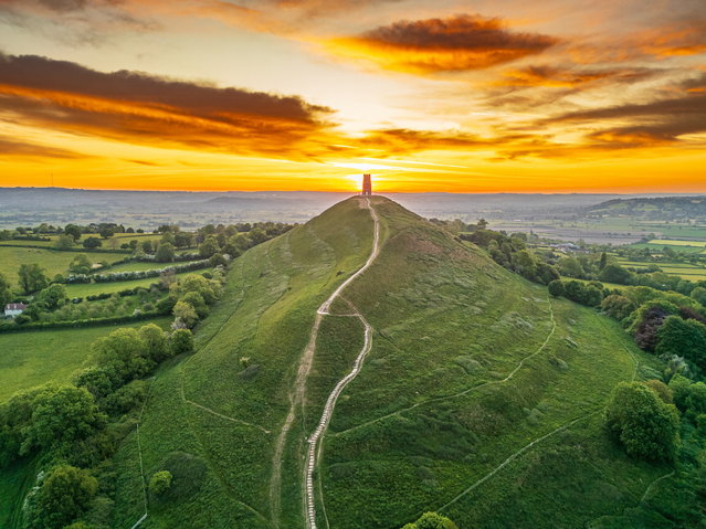 Dawn breaks over Glastonbury Tor in Somerset, UK on Sunday morning, May 11, 2025. Tuesday will see some thundery showers in the south, though it will be dry for most across the country. (Photo by Michelle Cowbourne/South West News Service)