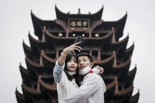 Tourists take a selfie in Yellow Crane Tower Park on October 7, 2020 in Wuhan, Hubei province, China. China is celebrating its national day from October 1 to 8, marking the 71st anniversary of the founding of the People's Republic of China. As there have been no recorded cases of community transmission in Wuhan since May, life for residents is gradually returning to normal. (Photo by Getty Images/Stringer)