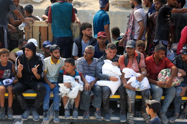 Palestinians sit as they seek aid supplies that entered Gaza through Israel, amid a hunger crisis, in Beit Lahia in the northern Gaza Strip on July 20, 2025. (Photo by Dawoud Abu Alkas/Reuters)