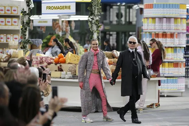 German designer Karl Lagerfeld (R) and British model Cara Delevingne appear at the end of his Fall/Winter 2014-2015 women's ready-to-wear collection show for French fashion house Chanel at the Grand Palais transformed into a “Chanel Shopping Center” during Paris Fashion Week, in this March 4, 2014 file photo. (Photo by Stephane Mahe/Reuters)
