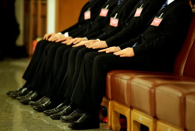 Members of the security personnel sit guard after the opening session of the National People's Congress (NPC) at the Great Hall of the People in Beijing, China March 5, 2018. (Photo by Jason Lee/Reuters)