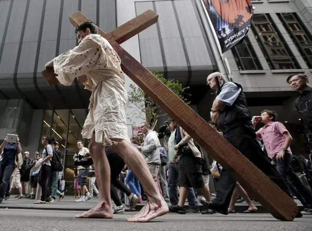 David Carnell plays a part of Jesus Christ during a “Journey to the Cross” procession while celebrating Good Friday in Sydney, Australia, Friday, March 29, 2013. The annual event by Wesley Mission tells the Easter story in a modern Australia. (Photo by Rick Rycroft/AP Photo)