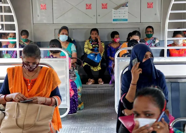 Women wearing protective face mask commute in a suburban train after authorities resumed the train services for women passengers during non-peak hours, amidst the coronavirus disease (COVID-19) outbreak, in Mumbai, India, October 21, 2020. (Photo by Niharika Kulkarni/Reuters)