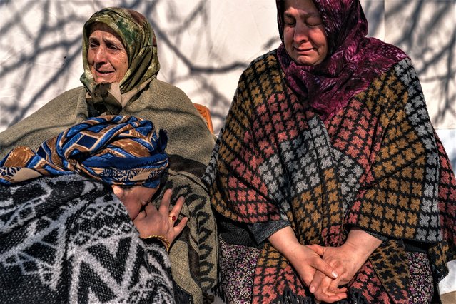 The family of Sakine Demir and her daughter greave as they gather at their home in the village of Colaklar near the town of Islahiye, Turkey, Sunday, February 12, 2023. The family wait for the fate of their relative who has been buried under the rubble since the 7.8-magnitude earthquake hit the region. (Photo by Salwan Georges/The Washington Post)