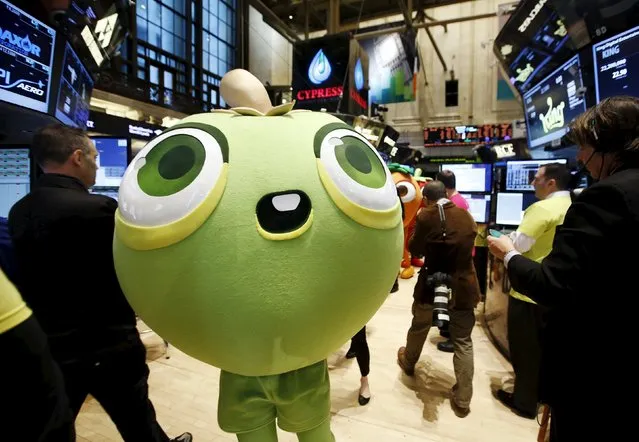 A mascot dressed as a character from the mobile game "Candy Crush Saga" walks the floor of the New York Stock Exchange during the IPO of Mobile game maker King Digital Entertainment Plc in this March 26, 2014 file photo. Video game maker Activision Blizzard Inc said it will buy "Candy Crush Saga" creator King Digital Entertainment for $5.9 billion to strengthen its games portfolio. (Photo by Brendan McDermid/Reuters)