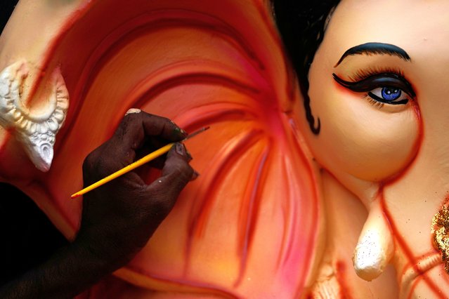 An artist colors an idol of elephant headed Hindu god Ganesha prepared for sale for the upcoming Ganesh Chaturthi festival, in Jammu, India, Friday, August 22, 2025. (Photo by Channi Anand/AP Photo)