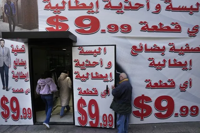 Store displays advertising in Arabic that reads “Italian clothes and shoes for 9.99 $” in Beirut, Lebanon, Wednesday, March 1, 2023. Lebanon started pricing consumer goods in U.S. dollars Wednesday as the value of the Lebanese pound hit new lows. (Photo by Hassan Ammar/AP Photo)