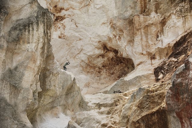 A worker pounds into rock to make gravel and sand in Kenscoff, a neighborhood of Port-au-Prince, Haiti, Thursday, July 24, 2025. (Photo by Odelyn Joseph/AP Photo)