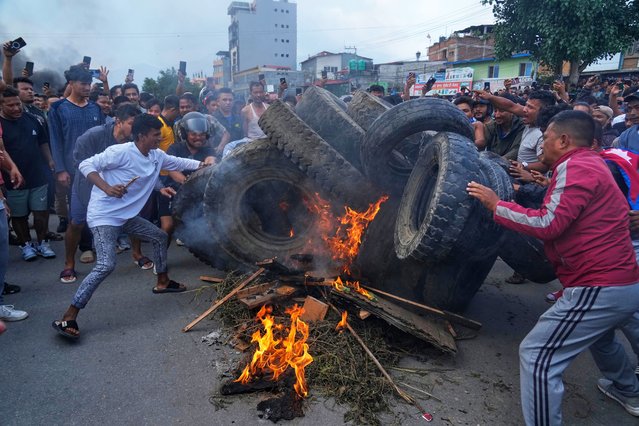 Protesters burn tires violating the curfew orders in Kathmandu, Nepal, Tuesday, September 9, 2025. (Photo by Niranjan Shrestha/AP Photo)