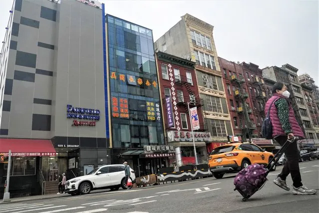 A six story glass facade building, second from left, is believed to be the site of a foreign police outpost for China in New York's Chinatown, Monday April 17, 2023. Justice Department officials say two men have been arrested on charges that they helped establish a secret police outpost in New York City on behalf of the Chinese government. (Photo by Bebeto Matthews/AP Photo)