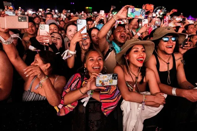 People watch Bad Bunny performing onstage at the Coachella Valley Music & Arts Festival in Indio, California, U.S., April 21, 2023. (Photo by Aude Guerrucci/Reuters)