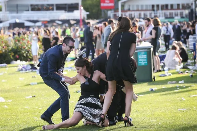 Racegoers enjoy the atmosphere following 2016 Derby Day at Flemington Racecourse on October 29, 2016 in Melbourne, Australia. (Photo by Splash News and Pictures)