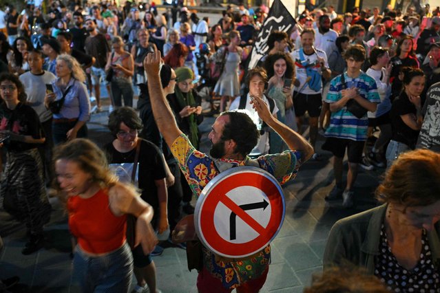 People celebrate after the first results of the second round of France's legislative election during an election night event in Marseille on July 7, 2024. A broad left-wing coalition was leading a tight French legislative election, ahead of both President's centrists and the far right with no group winning an absolute majority, projections showed. (Photo by Nicolas Tucat/AFP Photo)