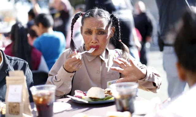 A person eats an early Thanksgiving meal served to the homeless at the Los Angeles Mission in Los Angeles, California, November 25, 2015. (Photo by Mario Anzuoni/Reuters)