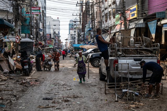 People are seen cleaning up damage in the commercial district in downtown Hat Yai as the flood waters receded on November 29, 2025 in Hat Yai, Thailand. Although the official number is still unconfirmed, the death toll of Hat Yai City alone is reportedly in the hundreds during major floods in Southern Thailand according to local media. (Photo by Sirachai Arunrugstichai/Getty Images)