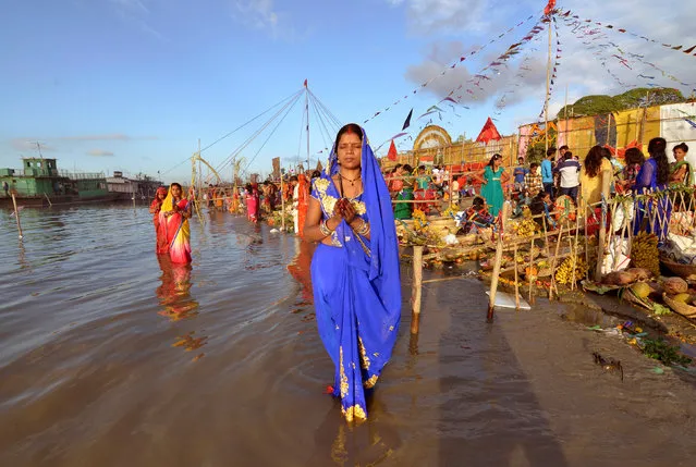 Hindu devotees worship the Sun god in the waters of the Brahmaputra river during Chhat Puja in Guwahati, India, November 6, 2016. (Photo by Anuwar Hazarika/Reuters)