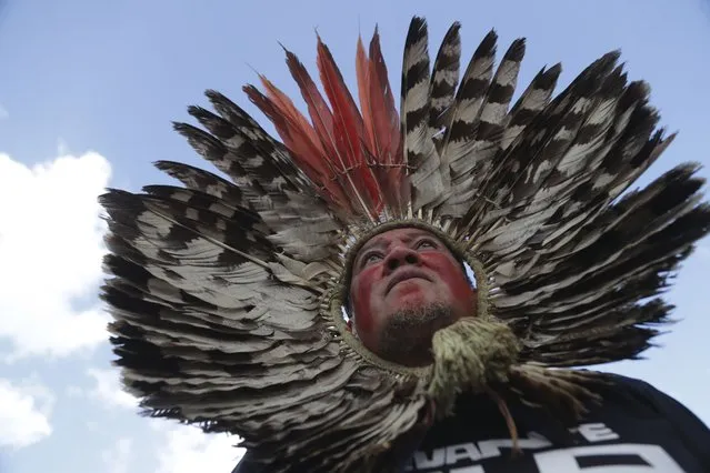 An Indigenous man takes part in a march to protest proposed legislation that would change the policy that demarcates Indigenous lands, in Brasilia, Brazil, Tuesday, May 30, 2023. (Photo by Gustavo Moreno/AP Photo)