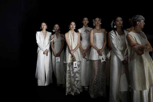 Models prepare backstage before the Nunu Nono collection by En Zhang during China Fashion week in Beijing on September 9, 2024. (Photo by Wang Zhao/AFP Photo)