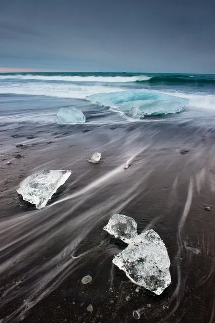 “Floating icebergs on black sand”. Jökulsárlón is a large glacial lagoon in southeast Iceland, on the borders of Vatnajökull National Park. It evolved into a lagoon after the glacier started receding from the edge of the Atlantic Ocean. (Photo and caption by Giacomo Ciangottini/National Geographic Traveler Photo Contest)