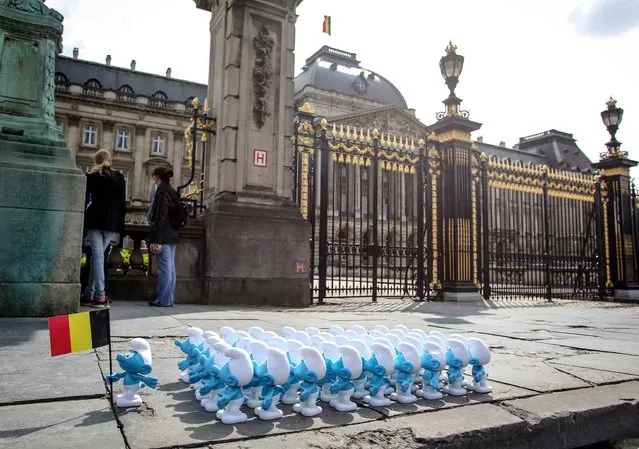 To bid farewell to King Albert II of Belgium the smurfs were installed in front of the palace in Brussels by a user of facebook, on July 3, 2013. (Photo by Olivier Vin/AFP Photo)