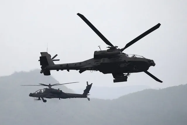 South Korea's AH-64 Apache helicopters hover in the sky during the live fire drill at Seungjin fire training center on May 25, 2023 in Pocheon, South Korea. South Korea and the United States are holding combined live-fire exercises on the occasion of the 70th anniversary of alliance. Last week North Korea condemned South Korea and the United States’ combined live-fire drills, describing the drills as a “war exercise” against the nation. (Photo by Chung Sung-Jun/Getty Images)