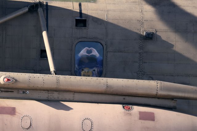 Newly released Israeli hostage Liri Albag, gestures a heart shape with her hands, from the window of a military helicopter as it prepares to land at the Shneider Children's Medical Centre in Petah Tikva, Israel on January 25, 2025. Four young women soldiers, abducted by Palestinian militants on October 7, 2023 while serving near the Gaza border, were released on January 25, following more than 15 months in captivity. (Photo by Jack Guez/AFP Photo)