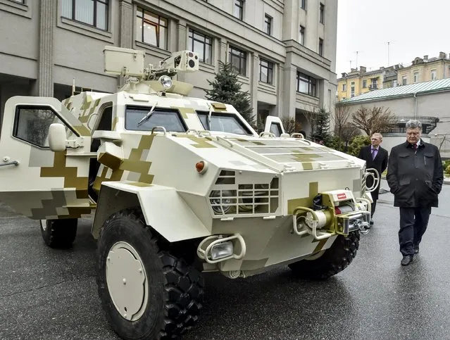 Ukraine's President Petro Poroshenko inspects an armoured vehicle in Kiev, January 30, 2015, in this handout courtesy of the Ukrainian Presidential Press Service. Poroshenko on Friday examined the first sample of the Dozor armoured personnel carrier (APC) produced by Lviv Armored Tank Plant of the State Corporate Group Ukroboronprom, according to the official presidential website. (Photo by Mykola Lazarenko/Reuters/Ukrainian Presidential Press Service)