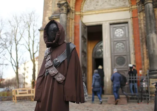 A person dressed as a character from the movie Star Wars attends a service at the church Zionskirche in Berlin, Germany, December 20, 2015. (Photo by Hannibal Hanschke/Reuters)