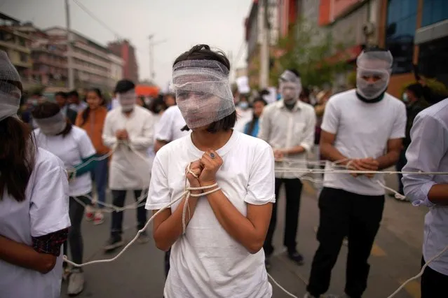 Civil Society members stage a symbolic demonstration in favor of democracy on the first day of the parliament session following the reinstatement of Federal Parliament in Kathmandu, Nepal on Sunday, 7 March 2021. (Photo by Skanda Gautam/Zuma Press/Profimedia)