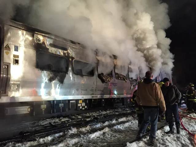 A Metro-North Railroad passenger train smolders after hitting a vehicle in Valhalla, N.Y., Tuesday, February 3, 2015. (Photo by Frank Becerra Jr./AP Photo/The Journal News)