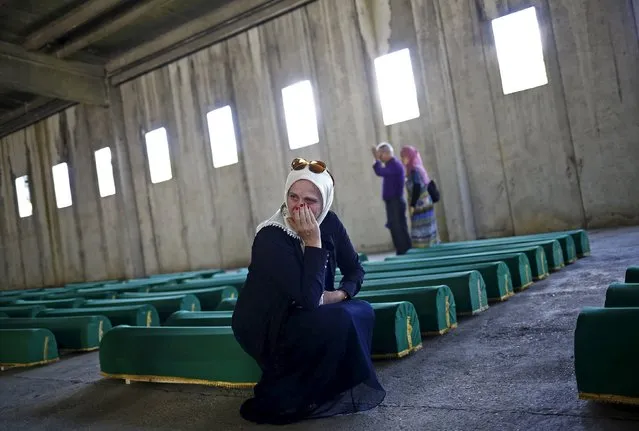 A woman cries near coffins containing the body of newly identified victims of the 1995 Srebrenica massacre at the Memorial Center in Potocari, near Srebrenica, Bosnia and Herzegovina July 10, 2015. (Photo by Stoyan Nenov/Reuters)