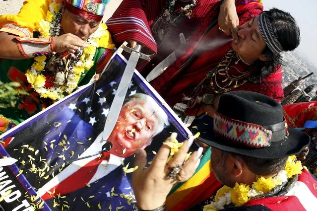 Peruvian shamans holding a poster of U.S. Republican presidential candidate Donald Trump perform a ritual of predictions for the new year at Morro Solar hill in Chorrillos, Lima, Peru, December 29, 2015. (Photo by Mariana Bazo/Reuters)