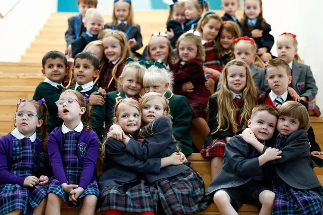 Fourteen sets of twins about to start the new school year in Inverclyde attend a group photograph at St Patrick’s Primary on August 11, 2023 in Greenock, Scotland. Seventeen sets of twins gear up for this year's school intake at St. Patrick's Primary Greenrock, bolstering “Twinverclyde” as the nickname of choice for the council area, with its remarkable history of high twin counts. (Photo by Jeff J. Mitchell/Getty Images)