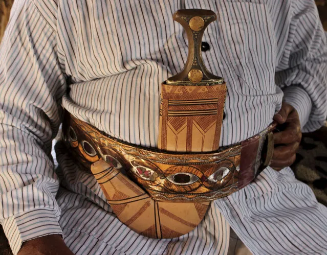 In this October 6, 2018, photo, a man wears a dagger or “Jambiyya” in Yemeni Arabic, made out of remains of missiles, in Hajjah, Yemen. (Photo by Hammadi Issa/AP Photo)