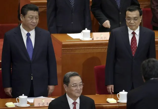 China's President Xi Jinping (L), Premier Li Keqiang (R) and Yu Zhengsheng (front), chairman of the National Committee of the Chinese People's Political Consultative Conference, stand during the opening session of Chinese People's Political Consultative Conference (CPPCC) at the Great Hall of the People in Beijing, March 3, 2015. REUTERS/Jason Lee