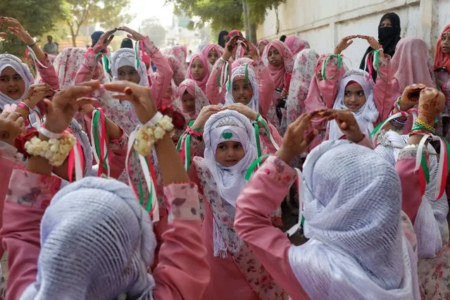 Girls wearing hijabs react on religious chant during the celebrations to mark the birth anniversary of Prophet Mohammad, in Karachi, Pakistan on September 29, 2023. (Photo by Akhtar Soomro/Reuters)